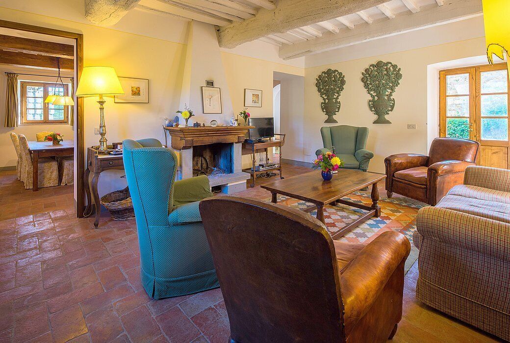 A cozy living room with a fireplace, comfortable seating, and a television.