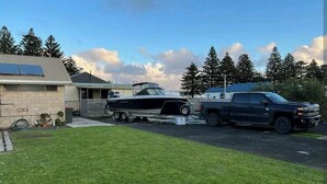 A residential area with a house, a truck, and a boat. - Budget acc (Port Macdonnell)