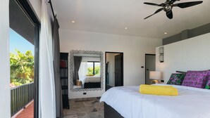 A bedroom with a large bed, a ceiling fan, a mirror, and a view of the outdoors. - Picturesque 4br Cape Yamu  Pool Villa (Pa Klok)