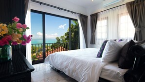 A bedroom with a large bed, a view of the ocean, and a balcony with potted plants. - Picturesque 4br Cape Yamu  Pool Villa (Pa Klok)