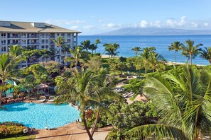 Relax by the resort's large pool surrounded by lush vegetation and enjoy breathtaking views of the ocean and distant mountains.
