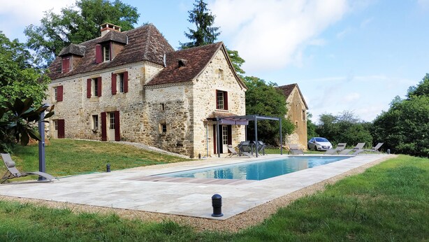 A stone house with a swimming pool, outdoor seating, and a car parked nearby. - Authentic 19th c Farmhouse  with heated pool fiber optic and air conditionné (Saint-Germain-des-Prés)
