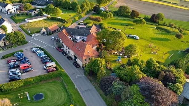 An aerial view of a rural area with a large building, a parking lot, and surrounding fields. - Beautiful Holiday Home in Voerendaal (Voerendaal)