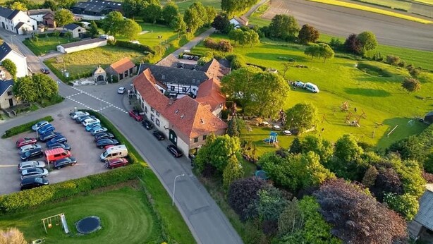 A rural area with a large building, a parking lot, and surrounding fields. - Cottage in Ubachsberg With Scenic Hills (Voerendaal)