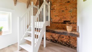 A staircase with white railings leading to a brick wall. - Comfortable Holiday Home in Voorst With Garden (Voorst)