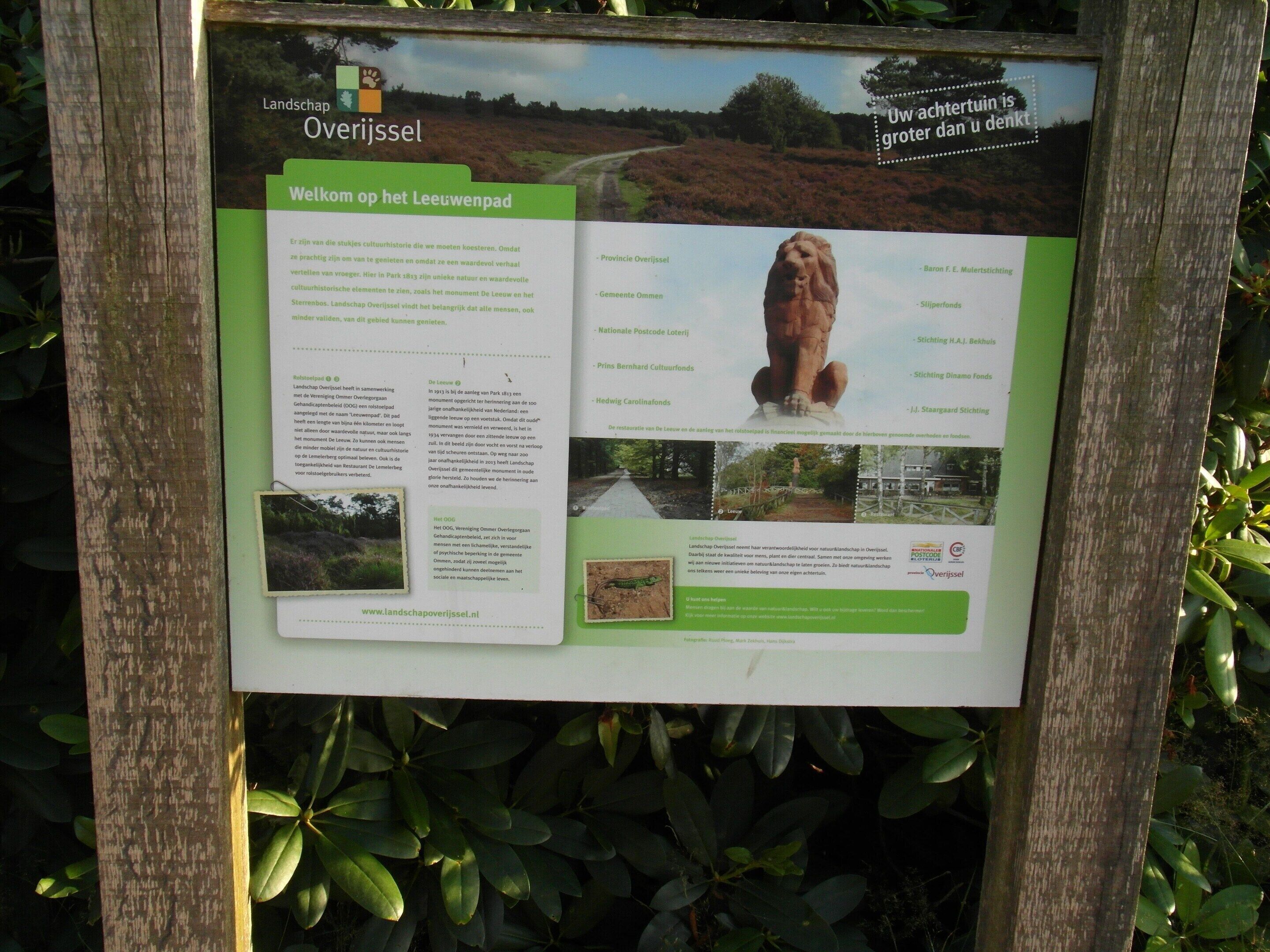 A signboard with information about Overijssel, including a welcome message, cultural history, and a scenic view of a landscape.