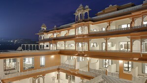 A multi-story building with balconies and reflective floors. - Fateh Vilas by Fateh Collection (Udaipur)