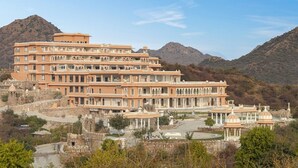 A multi-story hotel with a traditional architectural style, featuring a central courtyard and multiple balconies. - Fateh Vilas by Fateh Collection (Udaipur)