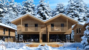 A wooden cabin with a central entrance, two side wings, and a snow-covered landscape. - #5b mit Sauna & Pool by Interhome (Sankt Georgen am Kreischberg)
