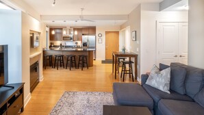 A modern living room with a gray sofa, a coffee table, and a patterned rug. - Mt. Tolmie View-Spacious, Bright NE Facing Two Bedroom Condo with Den by Victoria Prime! (Victoria)