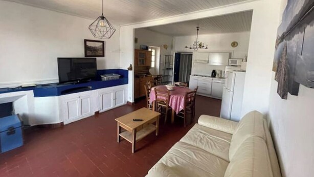 A living room with a sofa, a coffee table, a TV, and a dining area with a table and chairs. - Apartment-Propriano (Propriano)
