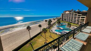 A hotel with a pool area, beach, and ocean view. - Sonoran Spa E603 - 2 BR Next to the Pool, High Speed Wi-Fi - Beachfront Upper Floor Luxury Condo (Puerto Peñasco)