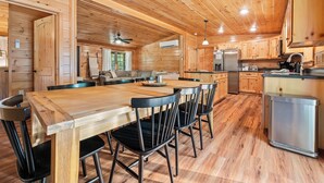 A spacious kitchen with wooden cabinets, a central island, and modern appliances.