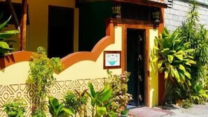 A two-story building with a balcony, surrounded by tropical plants. - Captal Island Villa (Mathiveri)