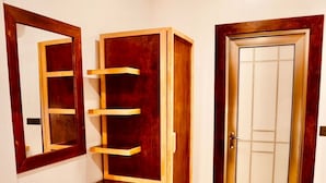 A room with a wooden cabinet, a mirror, and a door. - Captal Island Villa (Mathiveri)