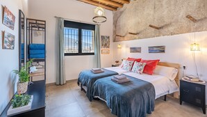 A bedroom with a bed, bedside tables, a window, and a mirror. - Country House 'La Criba - Casa Rural Eralta' with Mountain View, Wi-Fi and Air Conditioning (Dúrcal)
