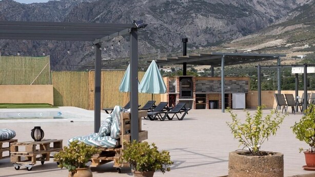 A rooftop terrace with lounge chairs, umbrellas, a barbecue area, and a pool. - Country House "Eralta" with Mountain View, Private Pool & Wi-Fi (Dúrcal)