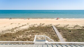 A beach with a wooden boardwalk leading to a beach area. - Welcome to One Fish Two Fish! (St. George Island)