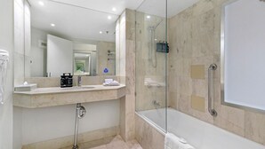 A modern bathroom with a glass-enclosed shower, a vanity with a sink, and a mirror. - Surfers Paradise Beach & Ocean View Unit (Level 13) 
 (Surfers Paradise)