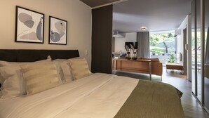 A modern hotel room with a large bed, a desk, and a balcony with a view. - Phaedrus Living Luxury Flat Vouliagmeni (Vari-Voula-Vouliagmeni)
