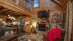A cozy log cabin interior with a kitchen, dining area, and living room. - Liam's Retreat - 2 Bedroom with GameRoom just minutes away from Pigeon Forge 2 Cabin by RedAwning (Sevierville)