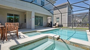 A swimming pool with a glass enclosure, surrounded by lounge chairs and a table. - Paradise Palms-6 bedrooms House w-pool-3509PP 6 Home by RedAwning (Kissimmee)