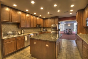 Enjoy cooking in this well-equipped kitchen with a central island, stainless steel oven, and dishwasher.