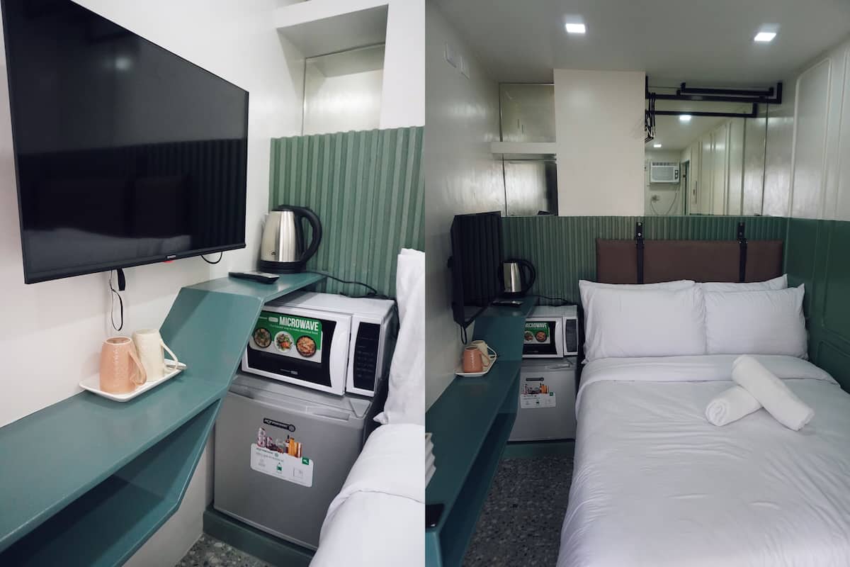 A hotel room with a bed, a microwave, a kettle, and a television.