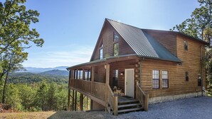 A wooden cabin with a porch and a staircase leading to the entrance. - Dunder Mountain Views Cabin Retreat 3 Bedroom Cabin by RedAwning (Sevierville)