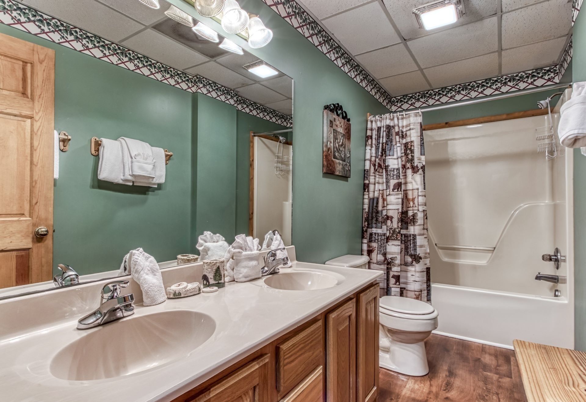 A bathroom with two sinks, a toilet, and a shower.