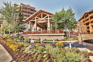 A Westgate building with a stone facade, wooden deck, and a sign. - 3701a Westgate 1 Bedroom Condo by RedAwning (Park City)