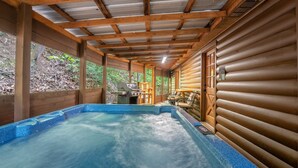 A hot tub area with wooden walls and a covered ceiling.