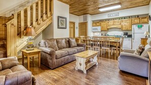 A wooden interior with a staircase, a dining area, and a kitchen. - Er202 - Now And Forever Great Location! - Close To Town! 4 Bedroom Cabin by RedAwning (Pigeon Forge)