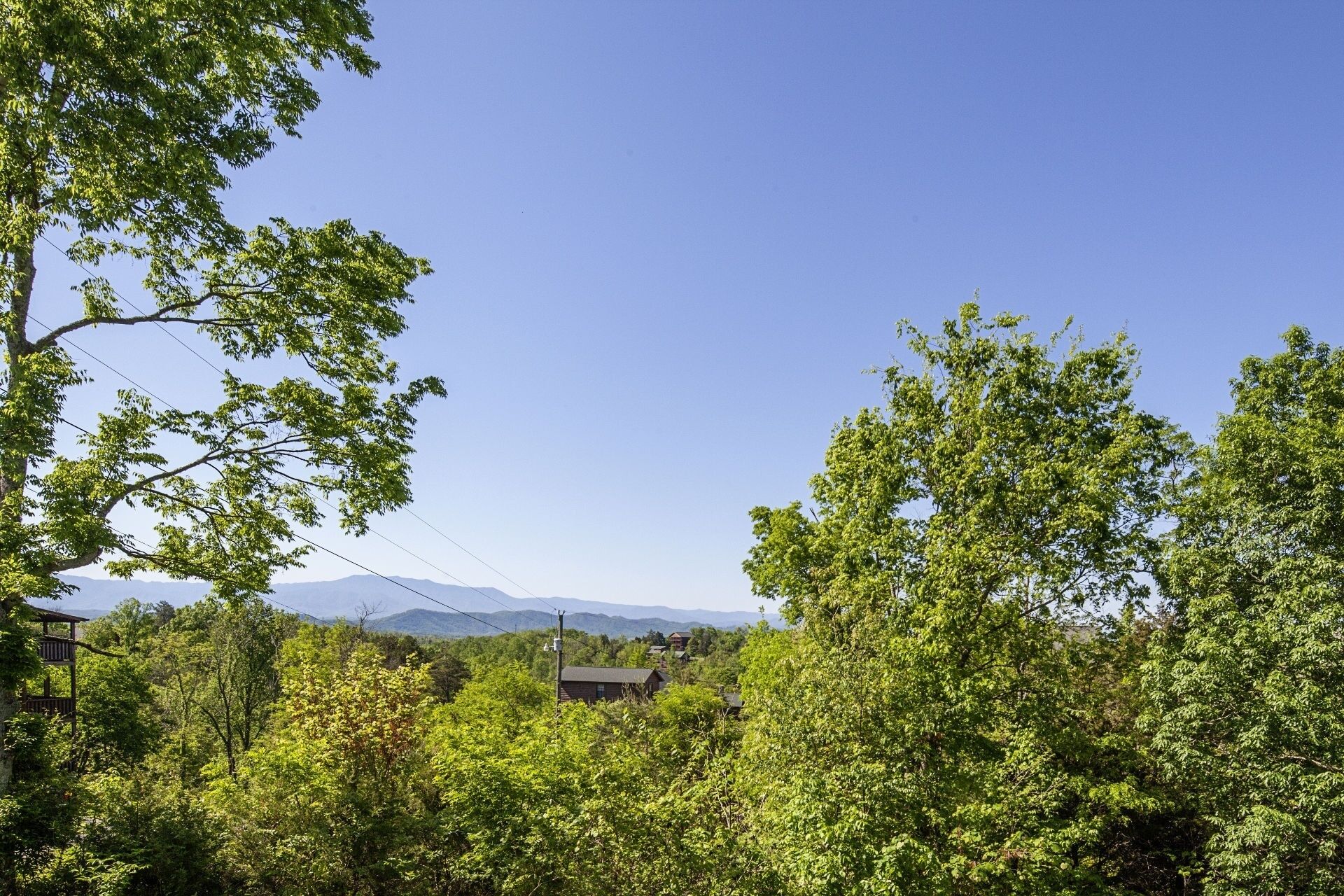 A view of a mountainous landscape with a clear sky.