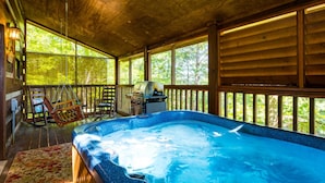 A hot tub in a wooden cabin with a view of trees. - Er17 - The Perfect Getaway Great Location - Close To Town! 1 Bedroom Cabin by RedAwning (Pigeon Forge)