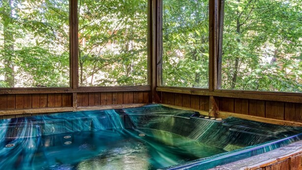 A hot tub with a wooden interior and large windows overlooking a forested area. - Er19 - Fryemont Great Location - Close To Town! 3 Bedroom Cabin by RedAwning (Pigeon Forge)