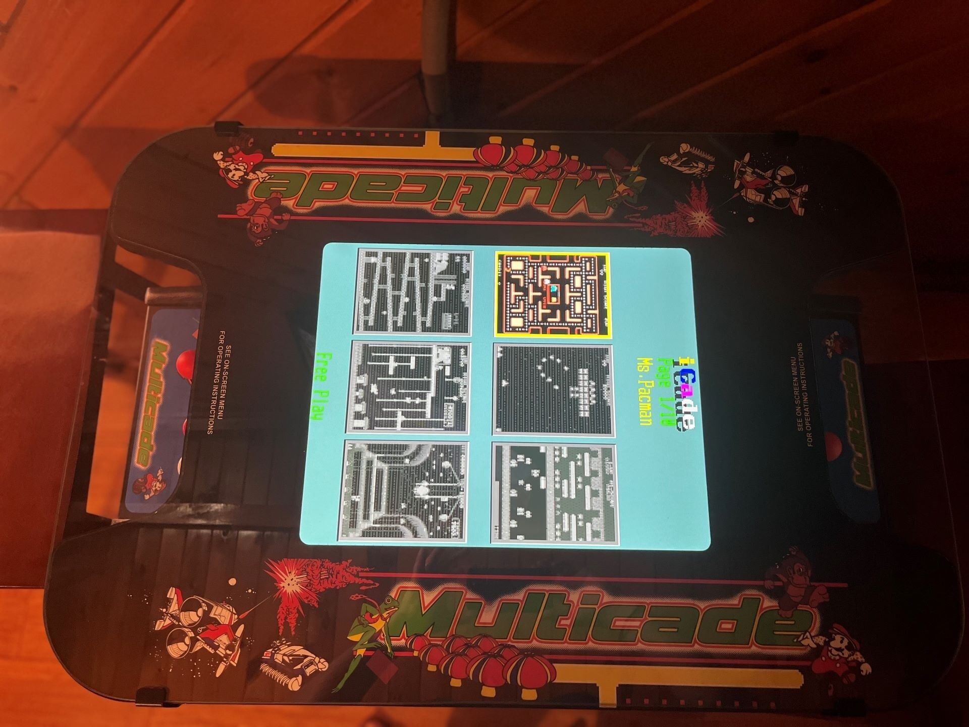 A video game console with a screen displaying a maze game.