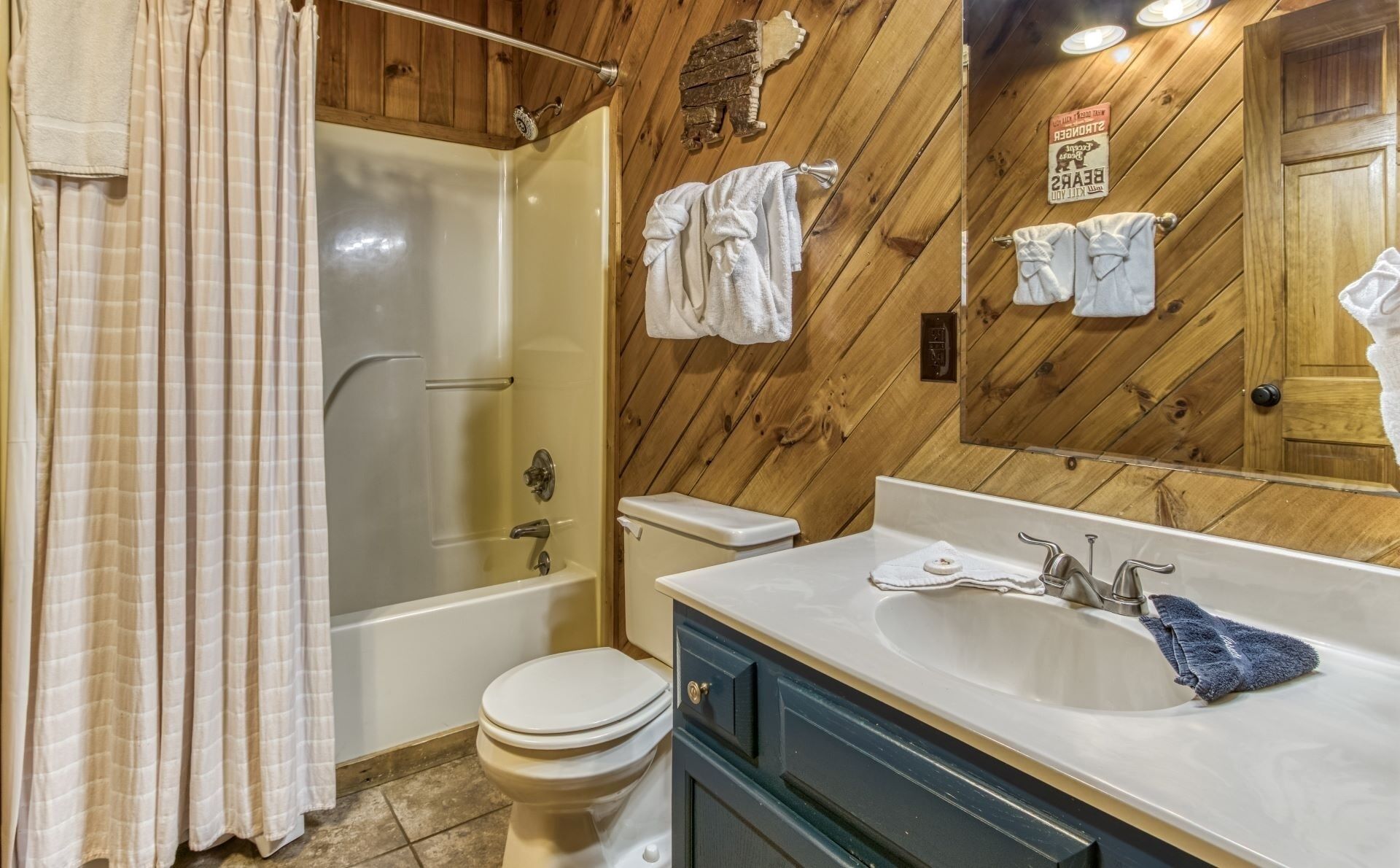 A bathroom with a bathtub, toilet, and sink.