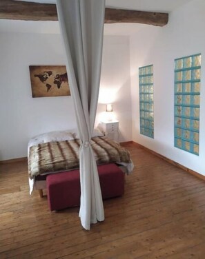 Cozy retreat with a comfortable bed, world map, and decorative wall art.