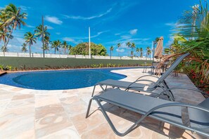 A swimming pool with lounge chairs and palm trees in the background. - Mana Beach Experience B16 - Carpediem (Ipojuca)