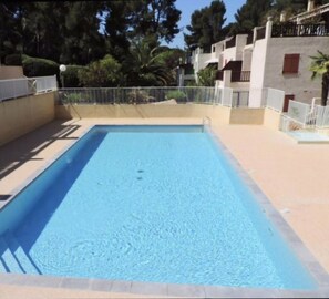 Enjoy a refreshing swim in this pool surrounded by a light-colored deck.