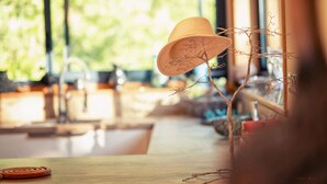 A hat on a table with a branch decoration.