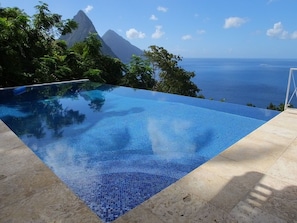 A infinity pool with a clear view of the ocean and mountains in the background. - Bananaquit House, large hillside Villa,  Piton View -  Direct from Owner  (Mamin)