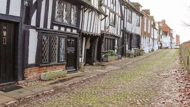 A row of traditional half-timbered houses with a cobblestone street. - Church View (Rye)