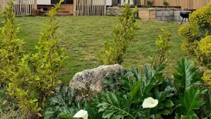 A modern two-story house with a sloped roof, large windows, and a wooden fence. - New ! Family home, 5 minutes from the sea! (La Forêt-Fouesnant)