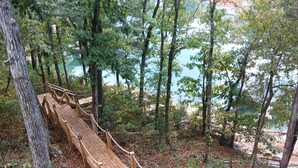 A wooden deck with a caution sign warning of slippery conditions when wet. - 25% late summer discount! Lakefront | 2 slip covered dock | Hot tub | (Speedwell)