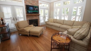 A living room with a fireplace, a television, a sofa, and a coffee table. - Beach luxury at it's best!! (Rehoboth Beach)