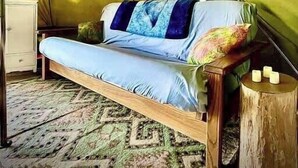 A tent with a bed inside, a small dresser, and a lamp. - Glamping Lakefront Island Retreat w/ Kayak & Pet-Friendly (Monmouth)