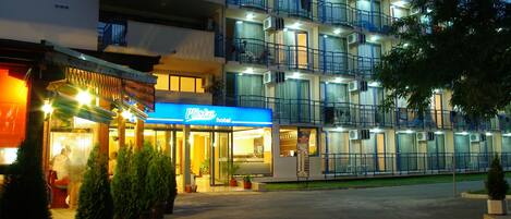 A hotel with multiple balconies and a reception area.