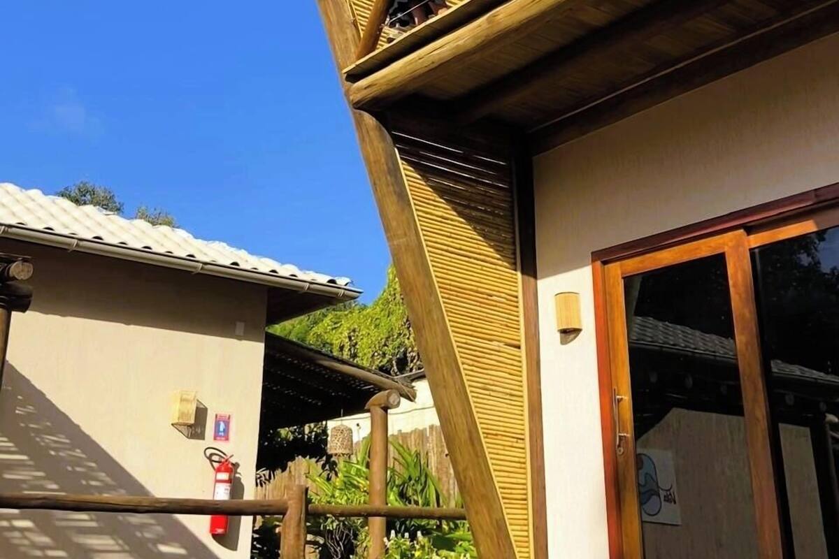 A two-story building with a wooden staircase leading to an upper balcony.